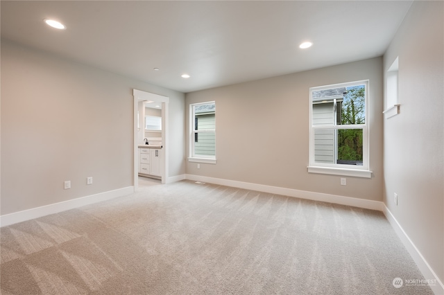 empty room featuring light colored carpet