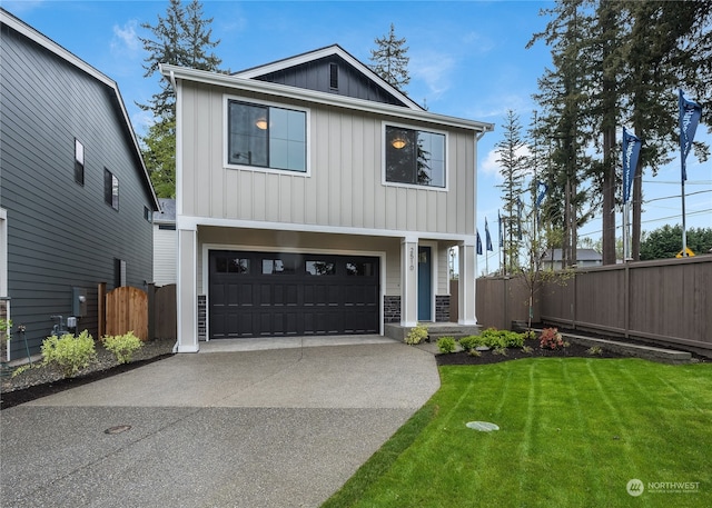 view of front of property featuring a garage and a front lawn