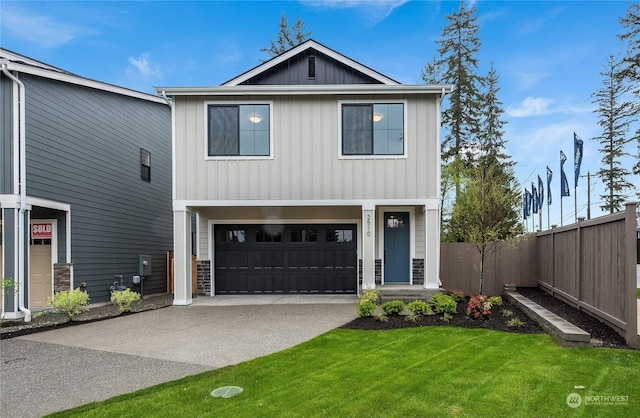 view of front of property featuring a garage and a front yard