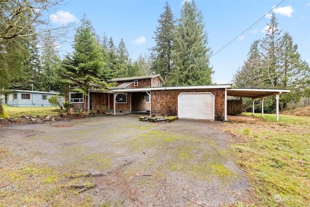 single story home featuring a garage, a front lawn, and a carport