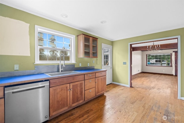 kitchen featuring sink, light hardwood / wood-style flooring, stainless steel dishwasher, and a chandelier