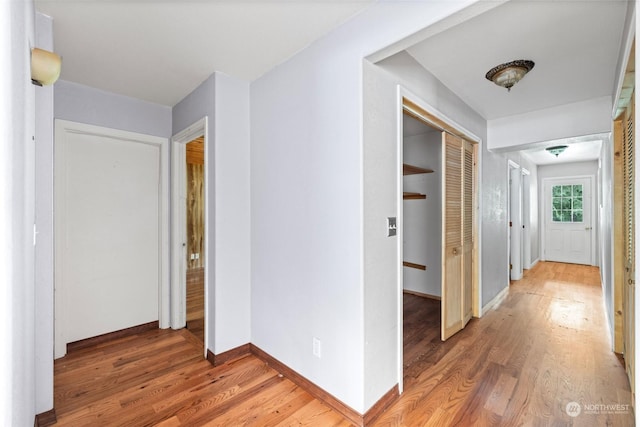 corridor with wood-type flooring