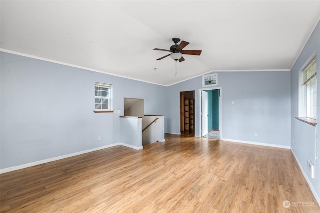 unfurnished living room with lofted ceiling, ornamental molding, light hardwood / wood-style floors, and ceiling fan