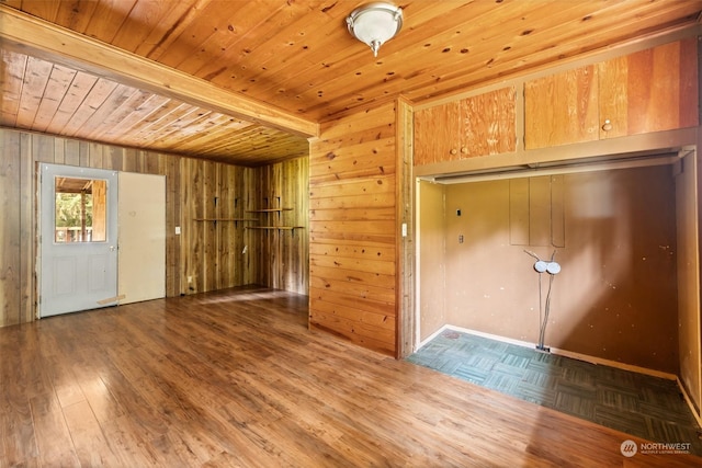 interior space with wood ceiling, wood-type flooring, wooden walls, and beamed ceiling