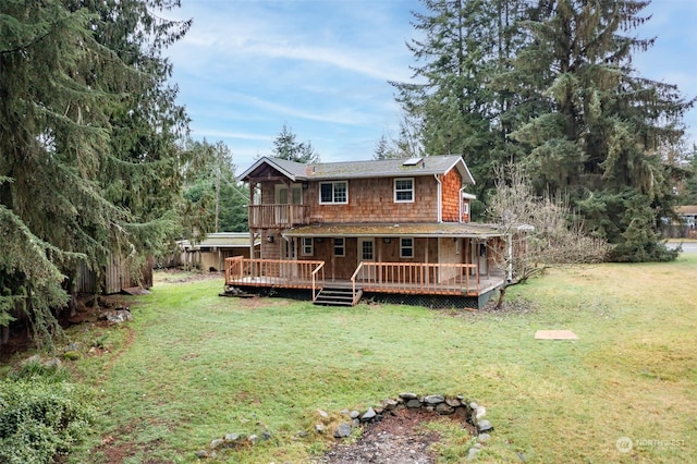 back of property with a wooden deck, a yard, and a hot tub