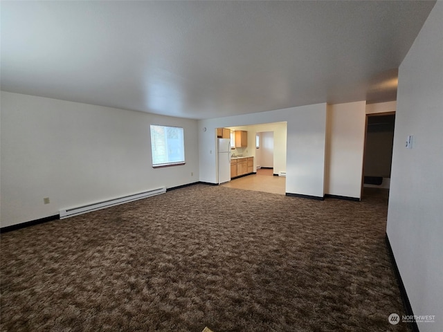 unfurnished living room with carpet floors and baseboard heating