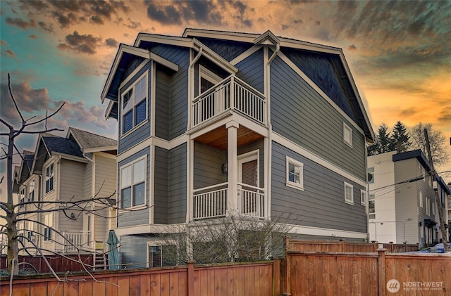 property exterior at dusk with a balcony