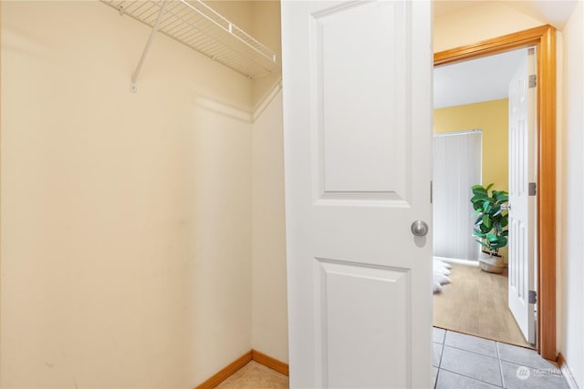 spacious closet featuring light tile patterned floors