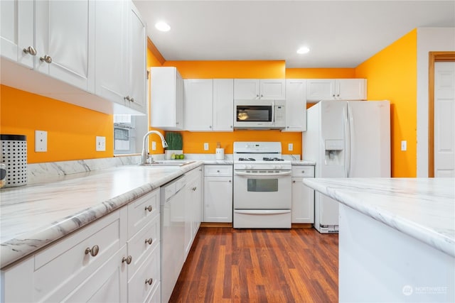 kitchen featuring sink, white appliances, dark wood-type flooring, light stone counters, and white cabinets