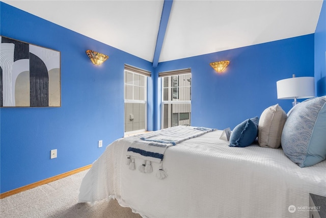 bedroom with lofted ceiling with beams and carpet flooring