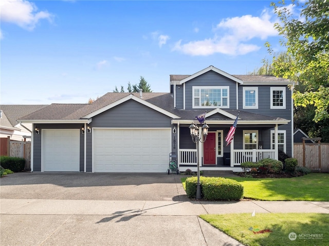 view of front of property featuring a garage, a porch, and a front yard