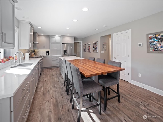 dining area with hardwood / wood-style flooring and sink