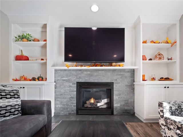 living room with dark hardwood / wood-style flooring and built in features