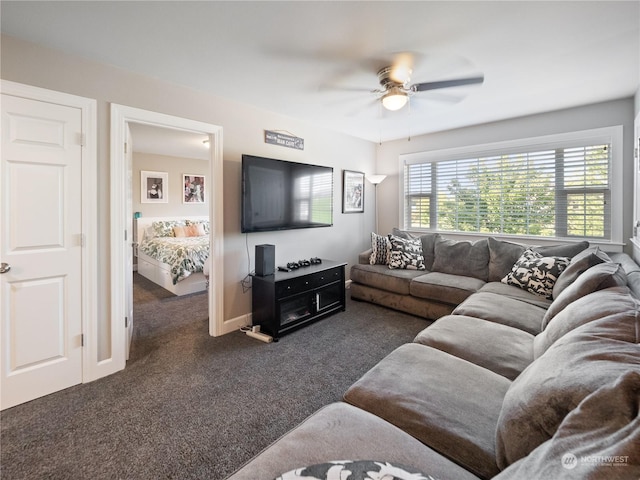 living room with ceiling fan and dark carpet