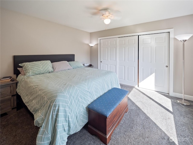 carpeted bedroom with ceiling fan and a closet