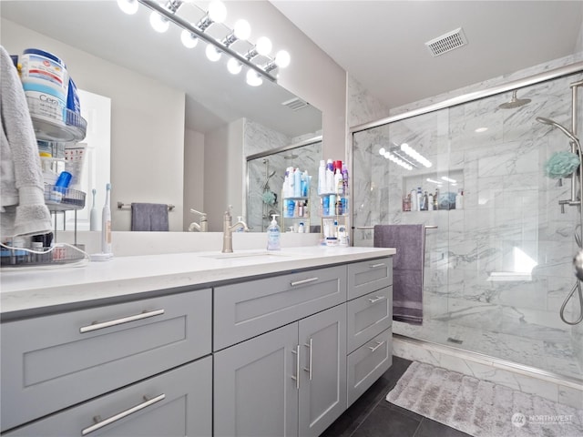 bathroom featuring vanity and an enclosed shower