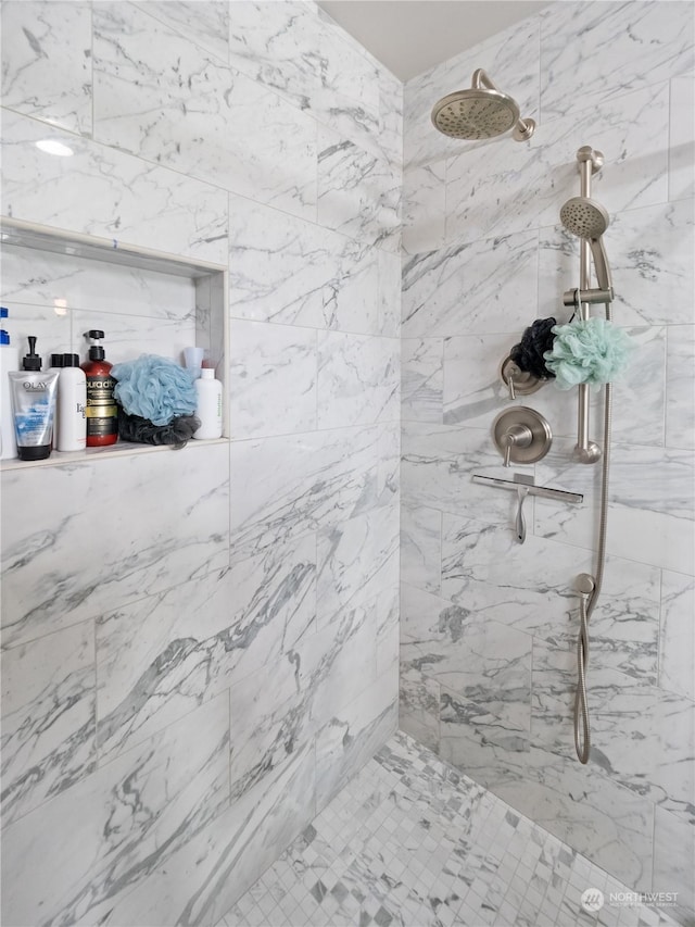 bathroom with a tile shower