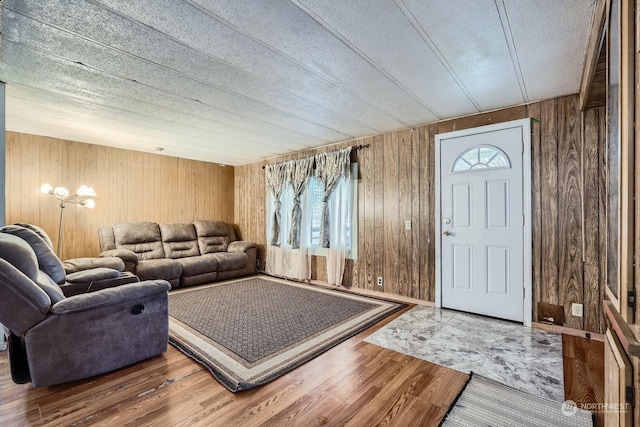 foyer entrance featuring wooden walls and hardwood / wood-style floors