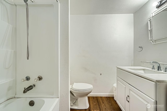 full bathroom featuring vanity, wood-type flooring, shower / tub combination, and toilet