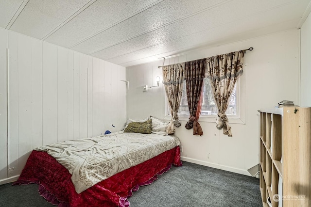 carpeted bedroom with wood walls