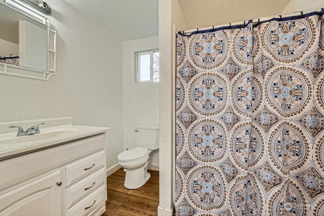 bathroom with a shower with curtain, wood-type flooring, vanity, and toilet