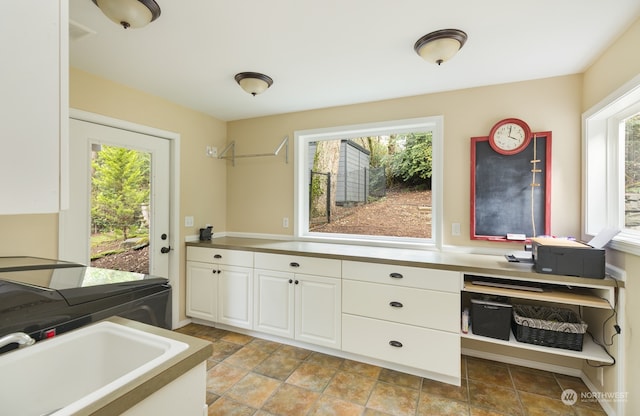 kitchen featuring sink, a wealth of natural light, and white cabinets