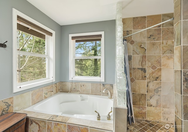 bathroom with independent shower and bath and plenty of natural light