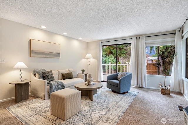 carpeted living room featuring recessed lighting, visible vents, a textured ceiling, and baseboards