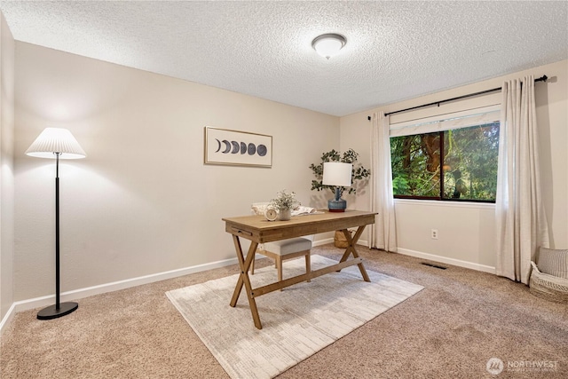 office space featuring light carpet, baseboards, visible vents, and a textured ceiling