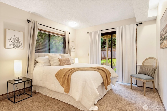 bedroom with multiple windows, access to exterior, a textured ceiling, and carpet floors