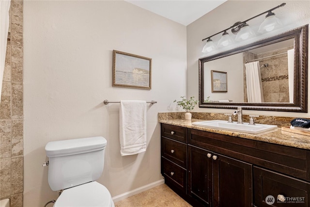 full bath with a tile shower, vanity, tile patterned flooring, toilet, and baseboards