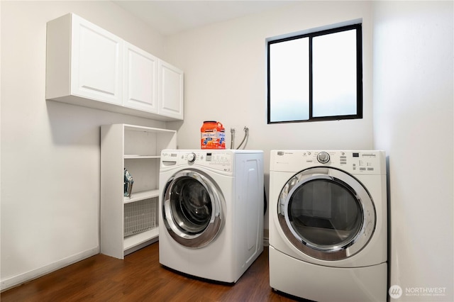 laundry area with cabinet space, washer and clothes dryer, baseboards, and dark wood-style floors