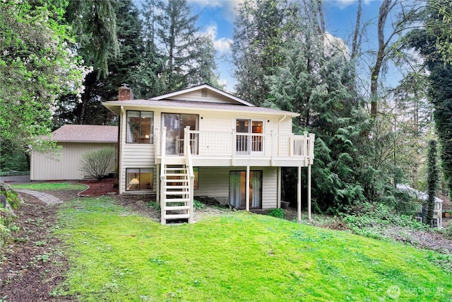 rear view of house with a yard, stairway, a deck, and a chimney