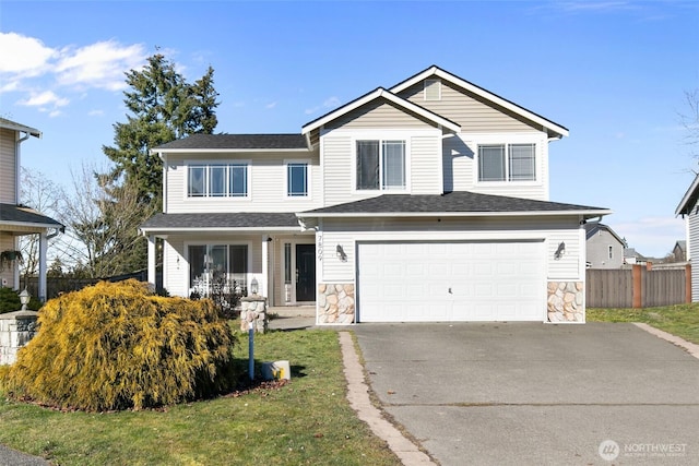 view of front of property featuring a garage and a front lawn