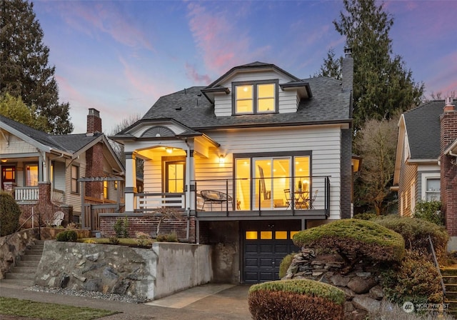 view of front of property with a garage and a balcony