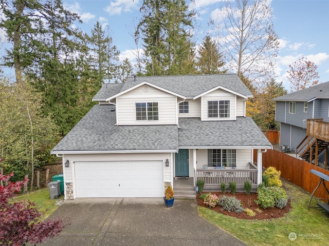 view of property with a garage and covered porch