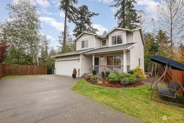 view of front property with a garage, covered porch, and a front lawn