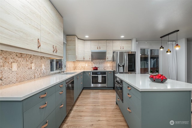 kitchen featuring a kitchen island, pendant lighting, sink, decorative backsplash, and stainless steel appliances