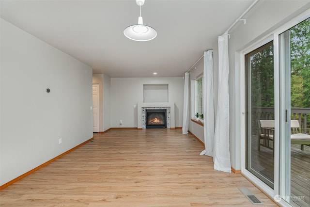 unfurnished living room with light hardwood / wood-style floors