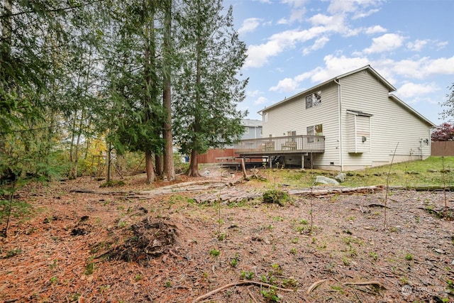 rear view of house featuring a wooden deck