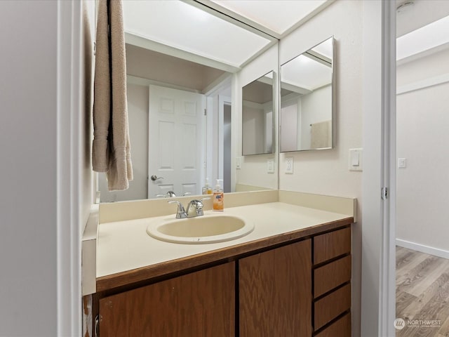 bathroom featuring hardwood / wood-style flooring and vanity