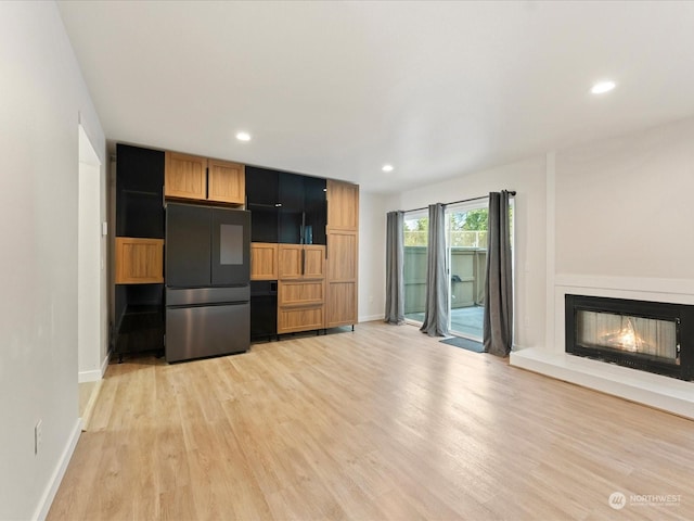 unfurnished living room featuring light wood-type flooring