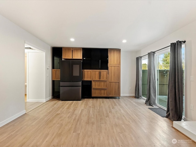 kitchen featuring black refrigerator and light hardwood / wood-style floors