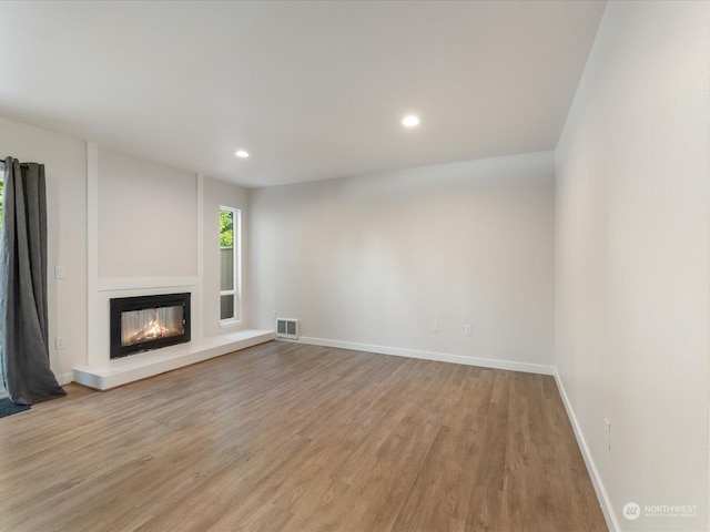 unfurnished living room featuring light hardwood / wood-style flooring