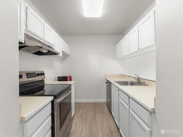 kitchen with appliances with stainless steel finishes, light hardwood / wood-style floors, sink, and white cabinets