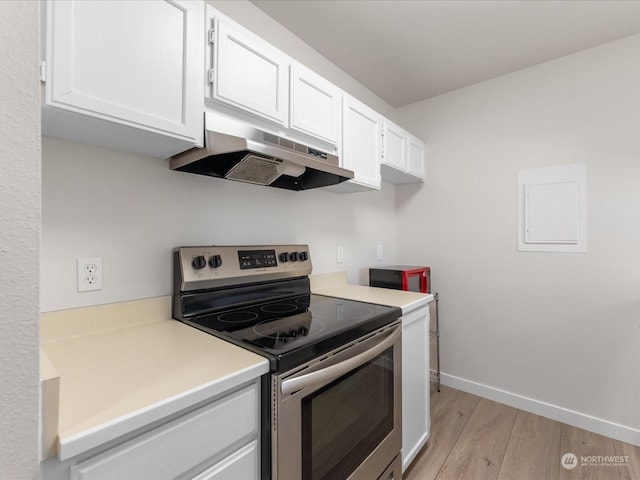 kitchen featuring light hardwood / wood-style flooring, stainless steel electric range, and white cabinets