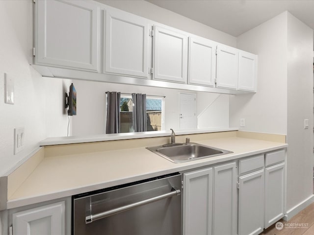 kitchen featuring white cabinetry, dishwasher, and sink