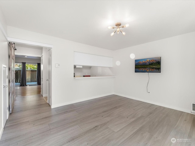 unfurnished room with light hardwood / wood-style flooring