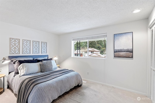 bedroom featuring carpet floors and a textured ceiling