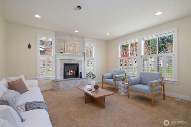 carpeted living area with plenty of natural light, a fireplace, baseboards, and recessed lighting